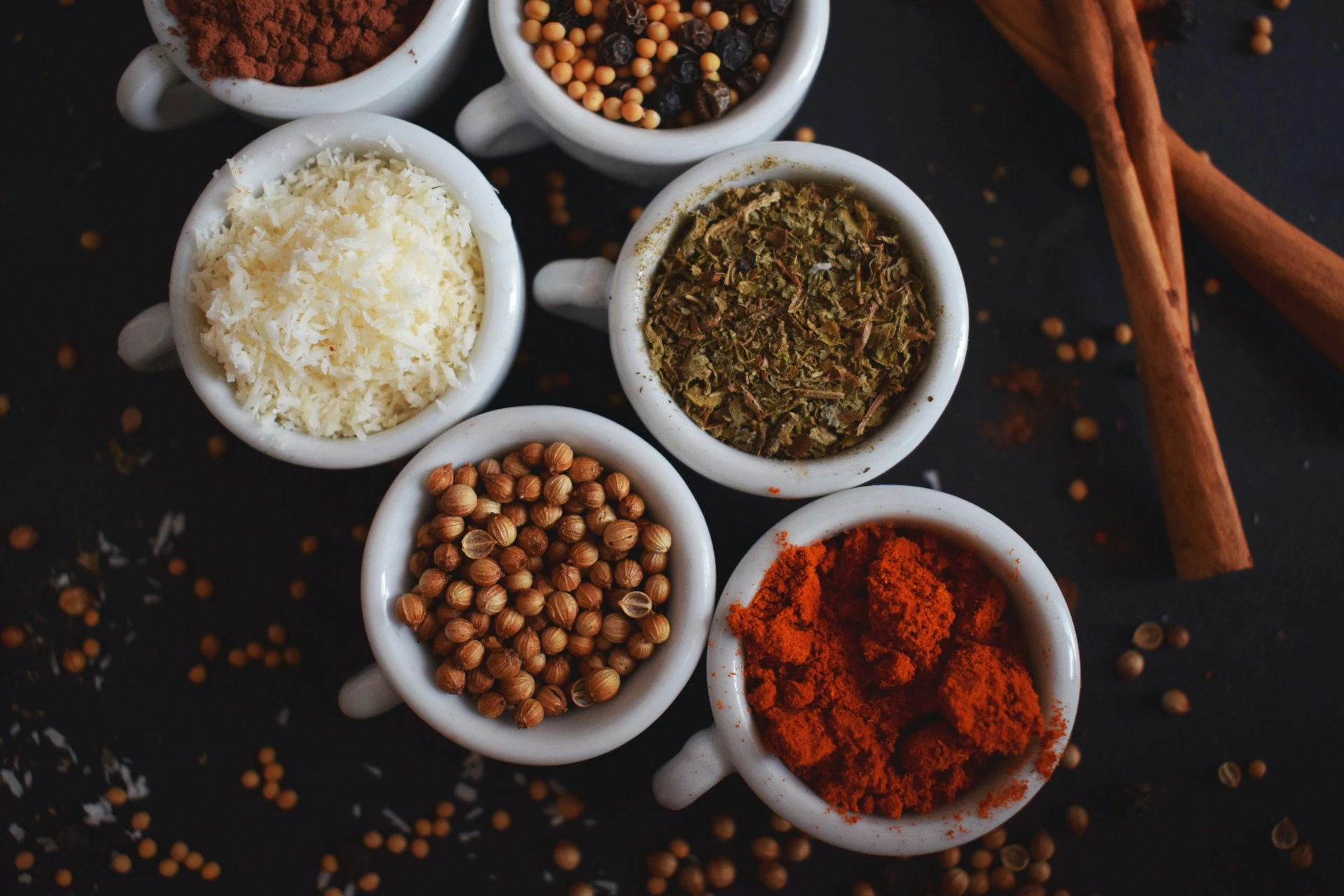 A collection of spices presented in mugs. A collection of spices presented in mugs.